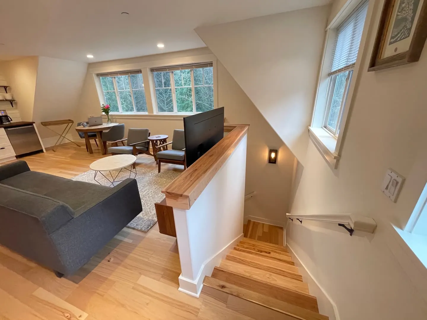 Open living area beside the staircase, with sofa and sitting nook